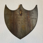 Framed Antique Metal Sign on White Linen Mat