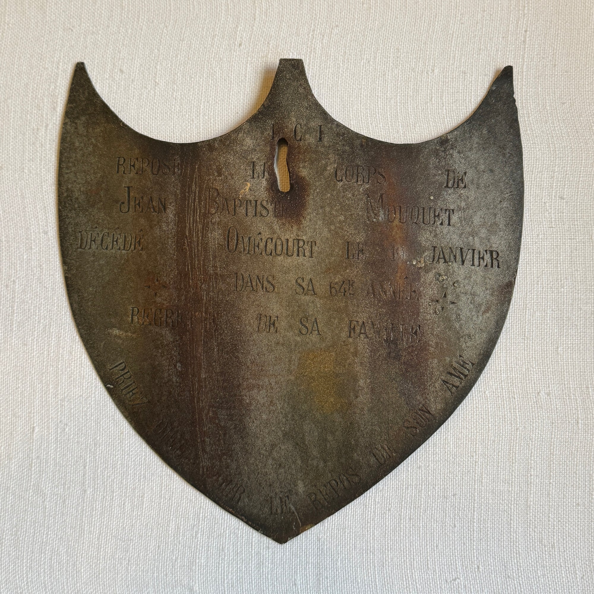 Framed Antique Metal Sign on White Linen Mat