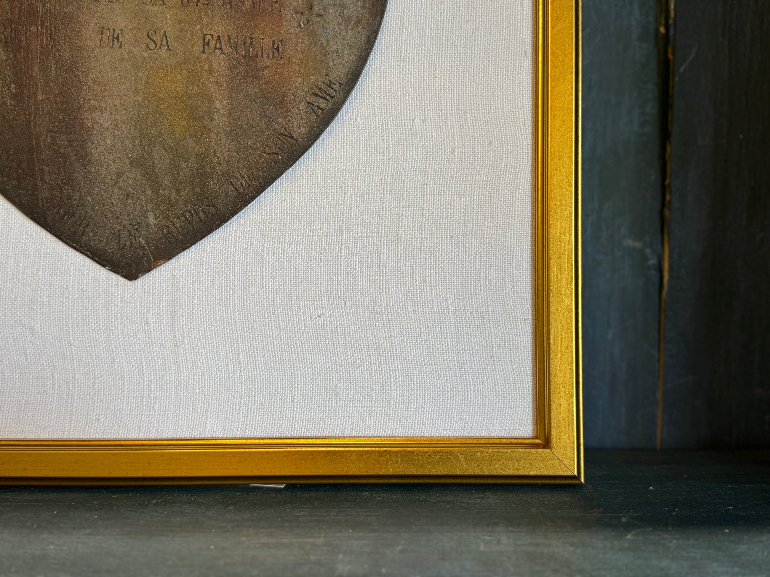 Framed Antique Metal Sign on White Linen Mat