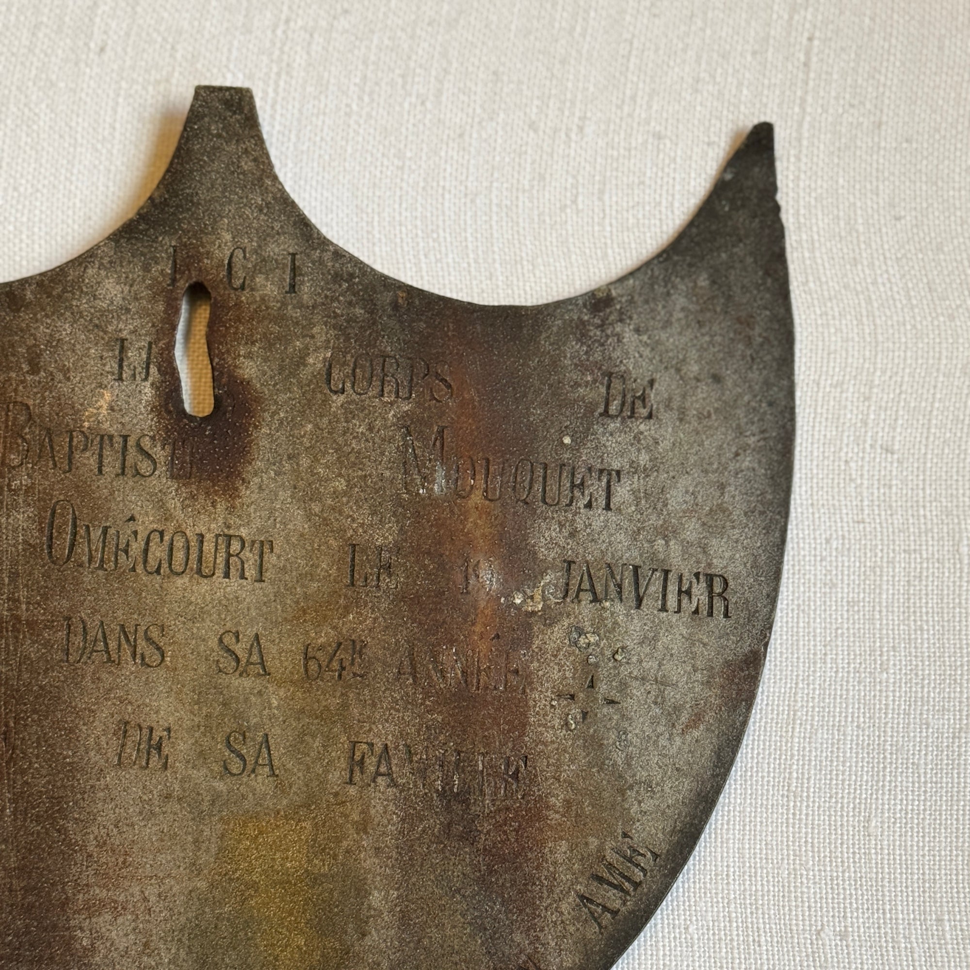 Framed Antique Metal Sign on White Linen Mat